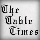 The Table Times Inc. logo