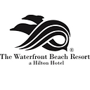 The Waterfront Beach Resort, A Hilton Hotel logo
